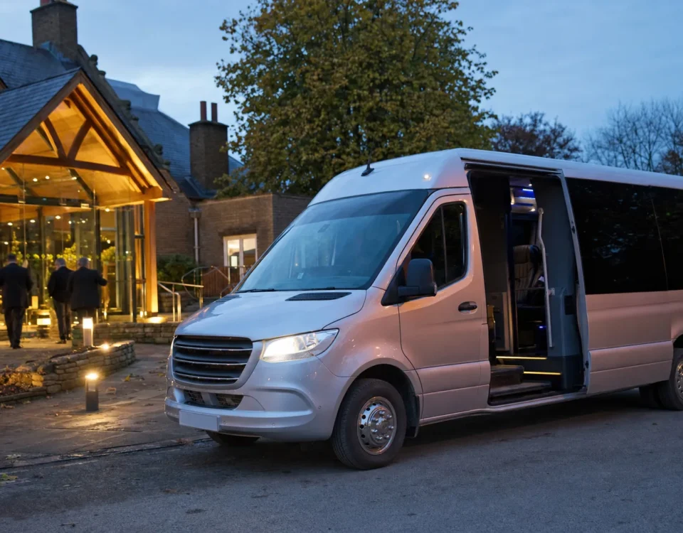 Executive minibus with professional driver parked at Heathrow Airport ready for group transfer