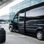 Executive minibus parked at Heathrow Airport with transparent pricing display showing fixed quote breakdown